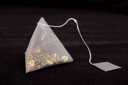 Pyramid shape teabag on the dark backgroundの写真素材