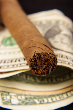 Expensive cigar on the dollar banknotes