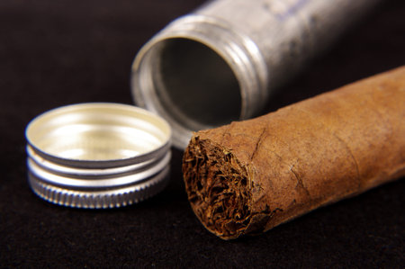 Macro closeup of cigar isolated on the black background