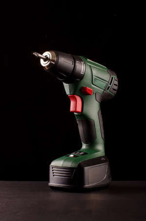 Cordless drill driver isolated on the black backgroundの写真素材
