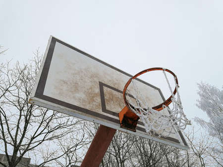 Basketball board with ice on the basketball net. Concept of abandoned placesの写真素材