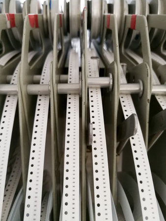 Paper reels with various electronic components resistors, capacitors, inductors close up
