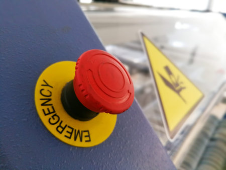 Red button on industrial machine for cancel and emergency stop of production line