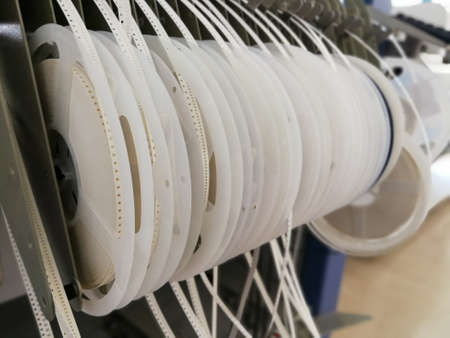 Paper reels with various electronic components resistors, capacitors, inductors close upの写真素材