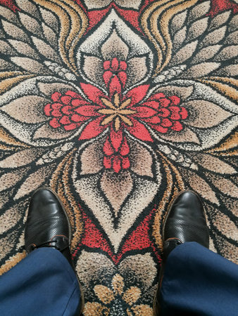 Businessman shoes close up on the russian style vintage decorated carpet