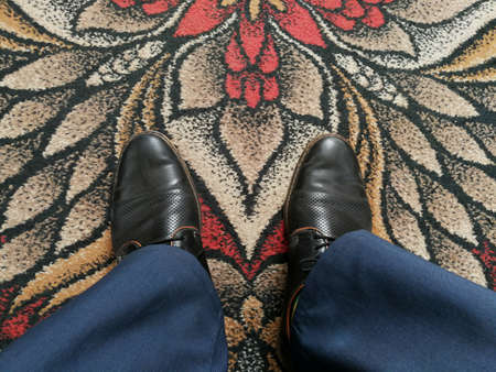 Businessman shoes close up on the russian style vintage decorated carpetの写真素材