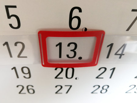 13th day marked with red marker on the office wall calendar