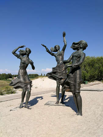 Sventoji, LITHUANIA - JULY 24, 2018 - Three ladies sculpture, called "Zvejo dukros" (eng. Fisherman's daughters) in the dunes of Sventoji, Lithuania. Sculptor Z.Pranaityte, 1982のeditorial素材