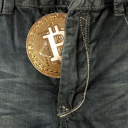 Concept of Bitcoin symbolic coin in the jeans pocketの写真素材