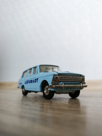 Old obsolete die cast model car on the wooden floor