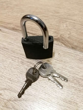 Metal padlock on the wooden floor. Security conceptの写真素材
