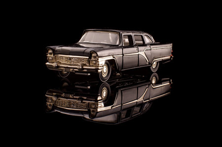 Luxury black soviet car die cast model on the black reflective surface