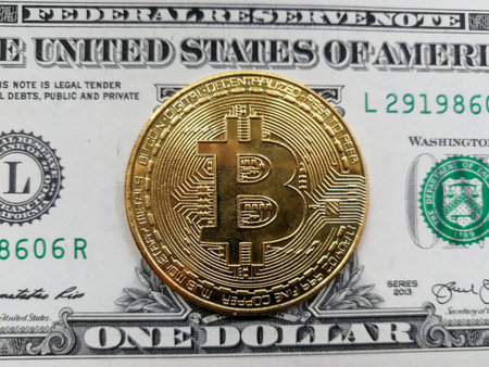 Symbolic golden bitcoin BTC coin in front of the dollar USD banknote