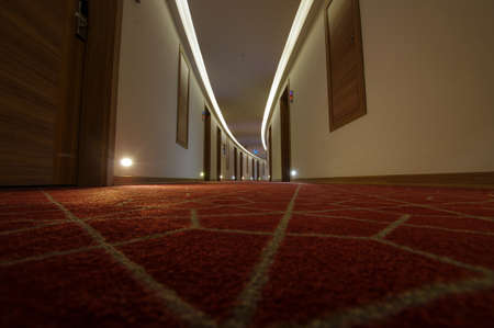 Empty luxury hotel coridor with red carpets, low angleの写真素材
