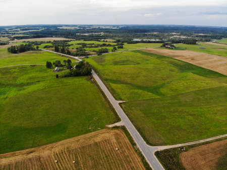 Aerial photography of autumn farm fields near Kraziai town in Lithuaniaの写真素材