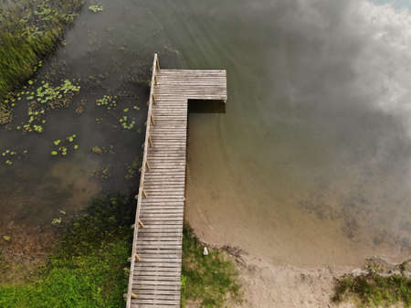Aerial view of wooden bridge to the natural lake in Lithuaniaの写真素材