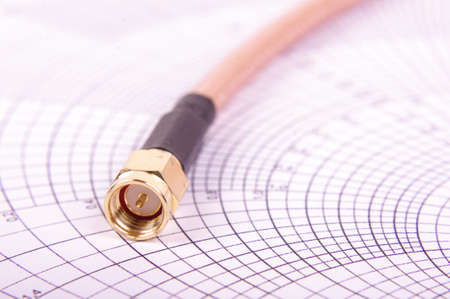 Macro close up of radio frequency cable with SMA connector on the Smith chartの写真素材