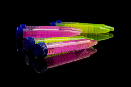 Test tube with vibrant color solution inside isolated on the black reflective backgroundの写真素材
