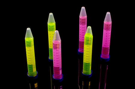 Test tube with vibrant color solution inside isolated on the black reflective background