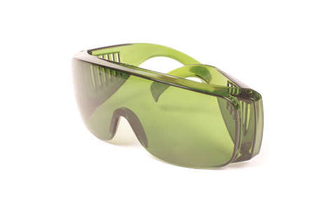 Safety green glasses for protection from laser radiation isolated on the white backgroundの写真素材