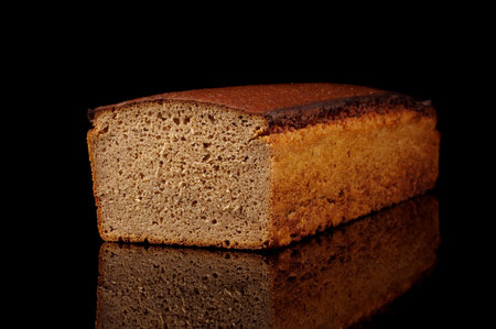 Traditional lithuanian rye bread (dark bread) loaf isolated on the black background