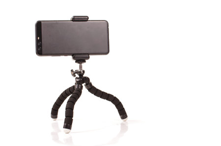 Adjustable universal smart phone tripod for remote recording and podcast isolated on the white...