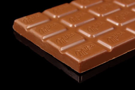 KAUNAS, LITHUANIA - MAY 01, 2020: Chocolate "Milka" with logo macro close up isolated on the black backgroundのeditorial素材