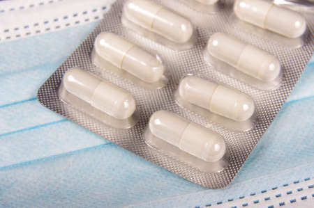 Medicine pills and virus protection face mask close upの写真素材