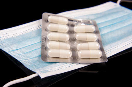 Medicine pills and virus protection face mask close upの写真素材