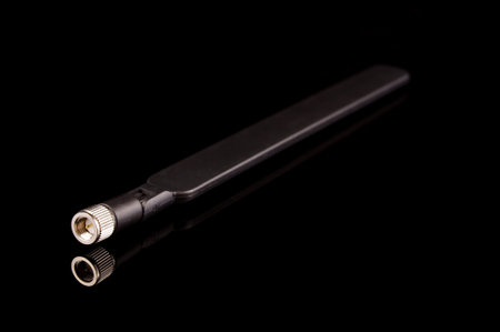 Monopole radio frequency transmission antenna for internet of things IoT and 5G technology isolated on the black backgroundの写真素材