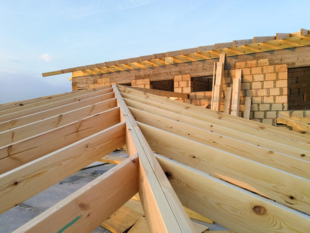 Wood girder beams for new roof construction at construction site