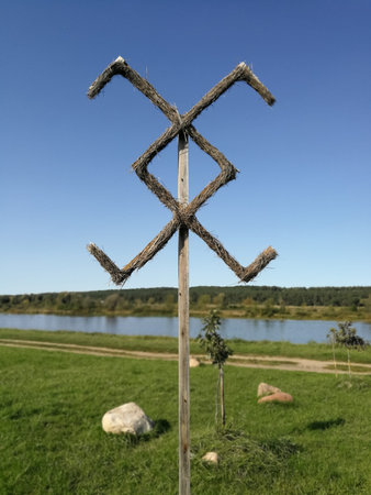 Old Lithuania Balt pagans symbol made from hey in front of blue sky