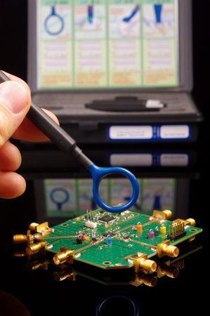 Electromagnetic compatibility (EMC) engineer holding magnetic near field probe for EMC...