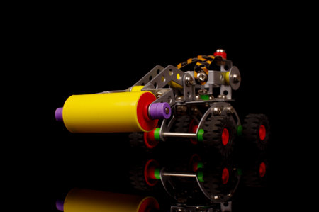 Child metal constructor road roller for mechanical assembly education isolated on the black backgroundの写真素材