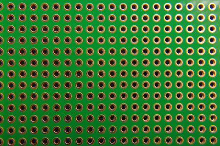 Empty universal printed circuit board PCB with drilled holed for elctronics component and...
