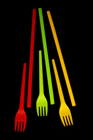 Plastic disposable utensil cutlery: yellow, green and red (Lithuania flag colors) forks and cocktail...