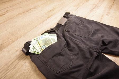 Many euro banknotes in the pocket of the jeans trousers