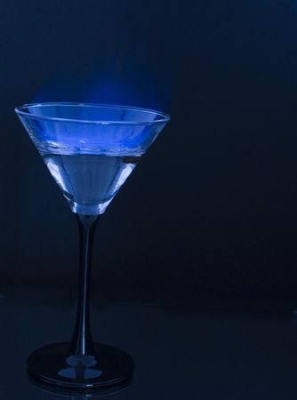 Flaming Sambuca cocktail with three coffee beans の写真素材