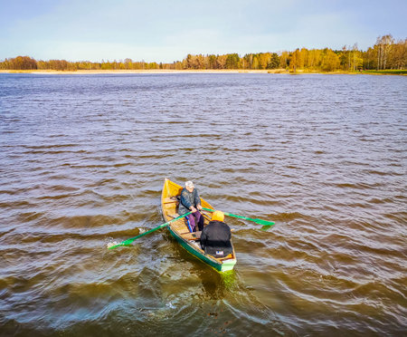 Birzai/Lithuania - 05 10 2020: Fishermen in the middle of the lake looking for fish