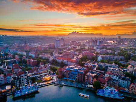 Aerial sunset view of the amazing old town of Gdansk (Poland), member of Hanseatic League with ships...