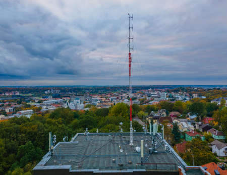 Aerial view of 4G, 5G cellular network antennas on the roof of a building in a big cityの写真素材