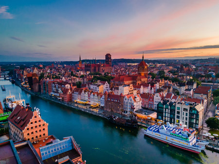 Aerial sunset view of the amazing old town of Gdansk (Poland), member of Hanseatic League with ships...