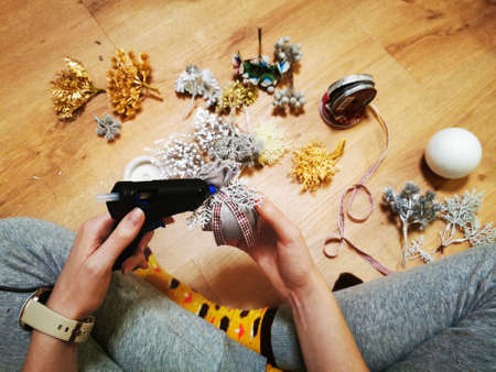 Girl making craft handmade Christmas tree toys with various materialsの写真素材