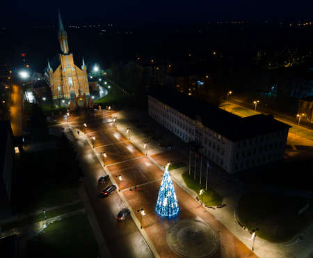 Aerial view of decorated Christmas tree and square heading to church in Kaisiarodys city, Lithuaniaの写真素材