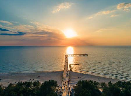 Aerial view of Palanga pedestrians bridge to the Baltic sea, straight way to it from Basanavicius street and a sunset in horizonの写真素材