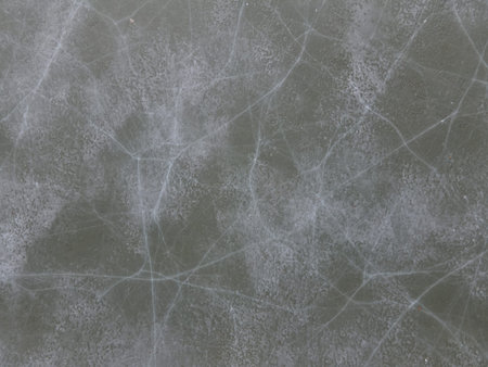 Aerial drone point of view of cracked ice on the lake from above