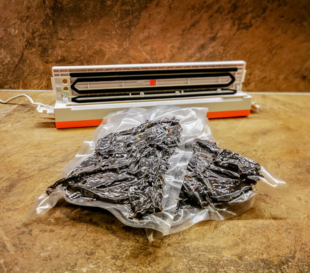 Photo of beef jerky packed using a vacuum packaging sealer on a table in the kitchen