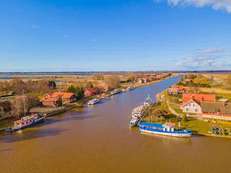 Minija or Minge (Lithuanian Venice) is a small unique fishermen's village in Lithuania on Minija river, and is part of Nemunas Delta Regional Park. It's unique as a main street is riverの写真素材
