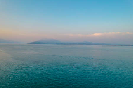 Aerial photo of lake Garda and mountains in horizon in Lombardy, Italyの写真素材