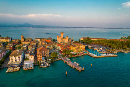Aerial panoramic view of Sirmione city old town on lake Garda in Lombardy, Italy. Evening photo with a castle in a centerの写真素材